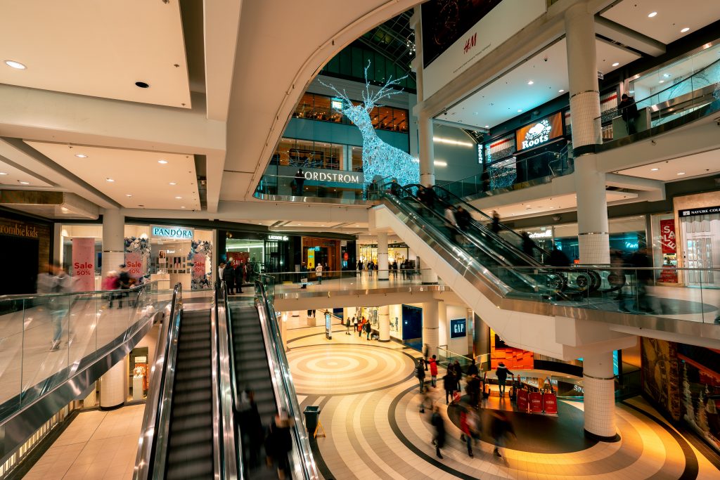 people walking on stairs and riding escalators